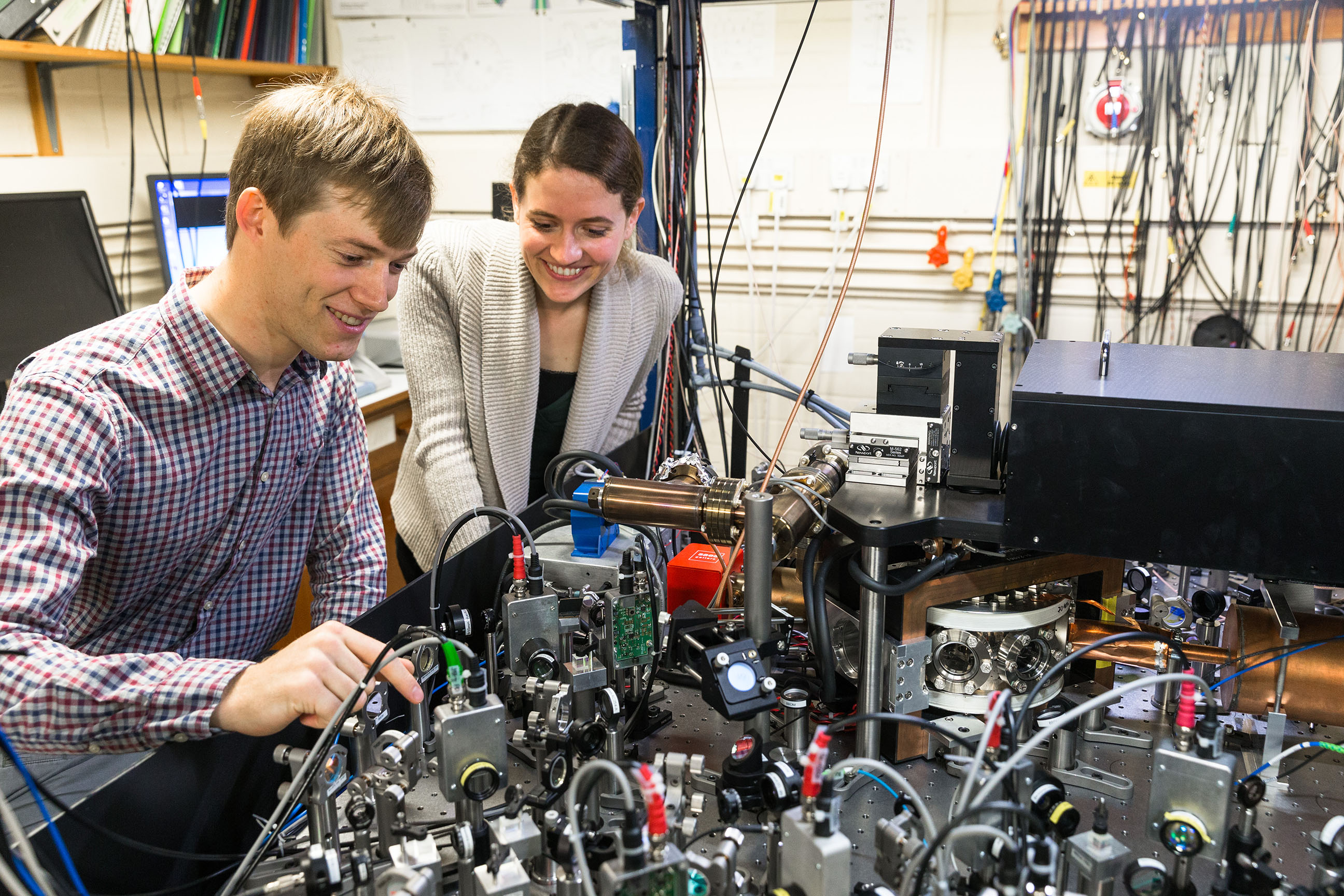 Lead authors, Vera Schäfer and Dr Chris Ballance, with the ion trap apparatus, Credit: David Fisher / NQIT